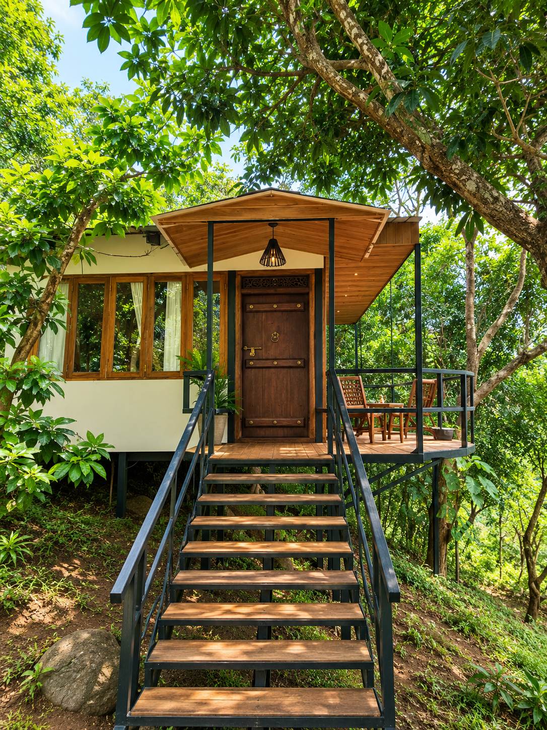 Vaaranam Farms cottage among the trees, stairway to the deck